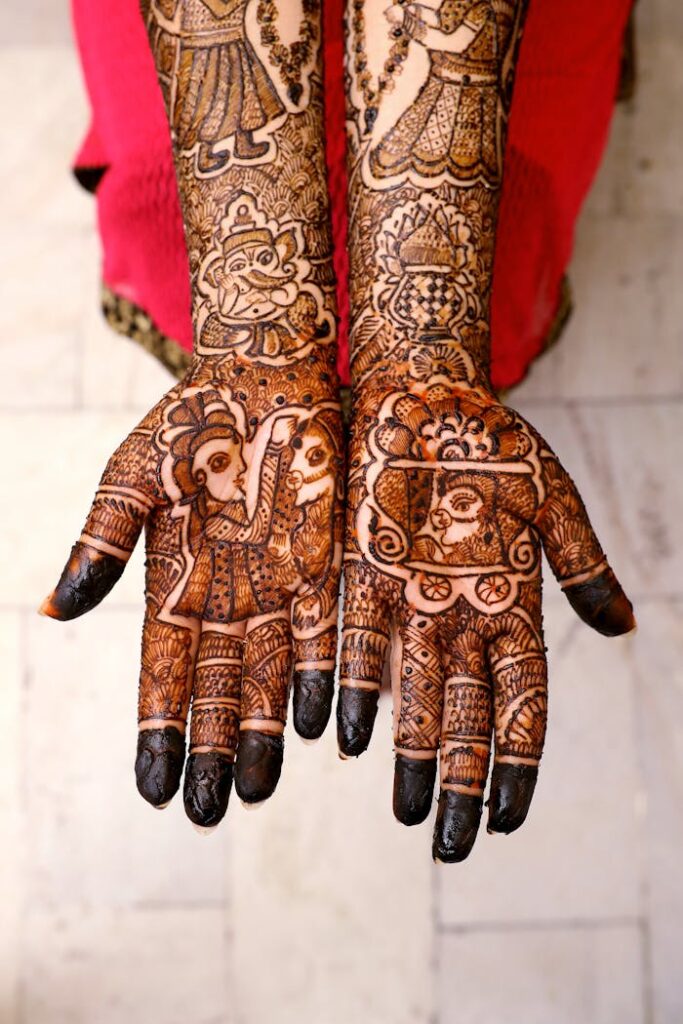 Beautiful mehndi art covers the hands of an adult woman, showcasing traditional cultural patterns.